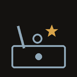 A drawer of cheerful clutter: a crooked stick, a ball, a gold star